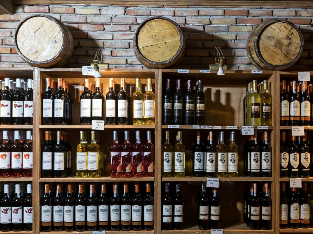 A wall of wine bottles in a large cellar