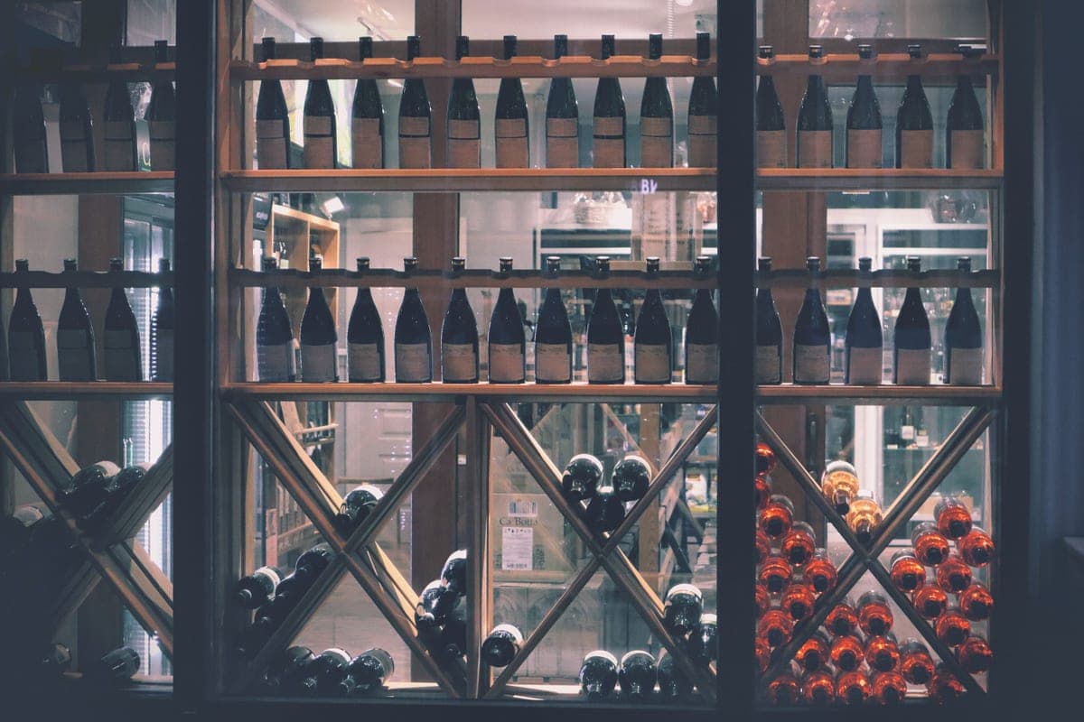 Wine bottles lined up on a retail shelf
