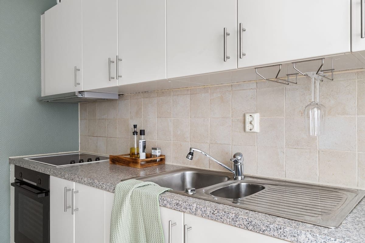 Wine glasses and a bottle on a kitchen countertop