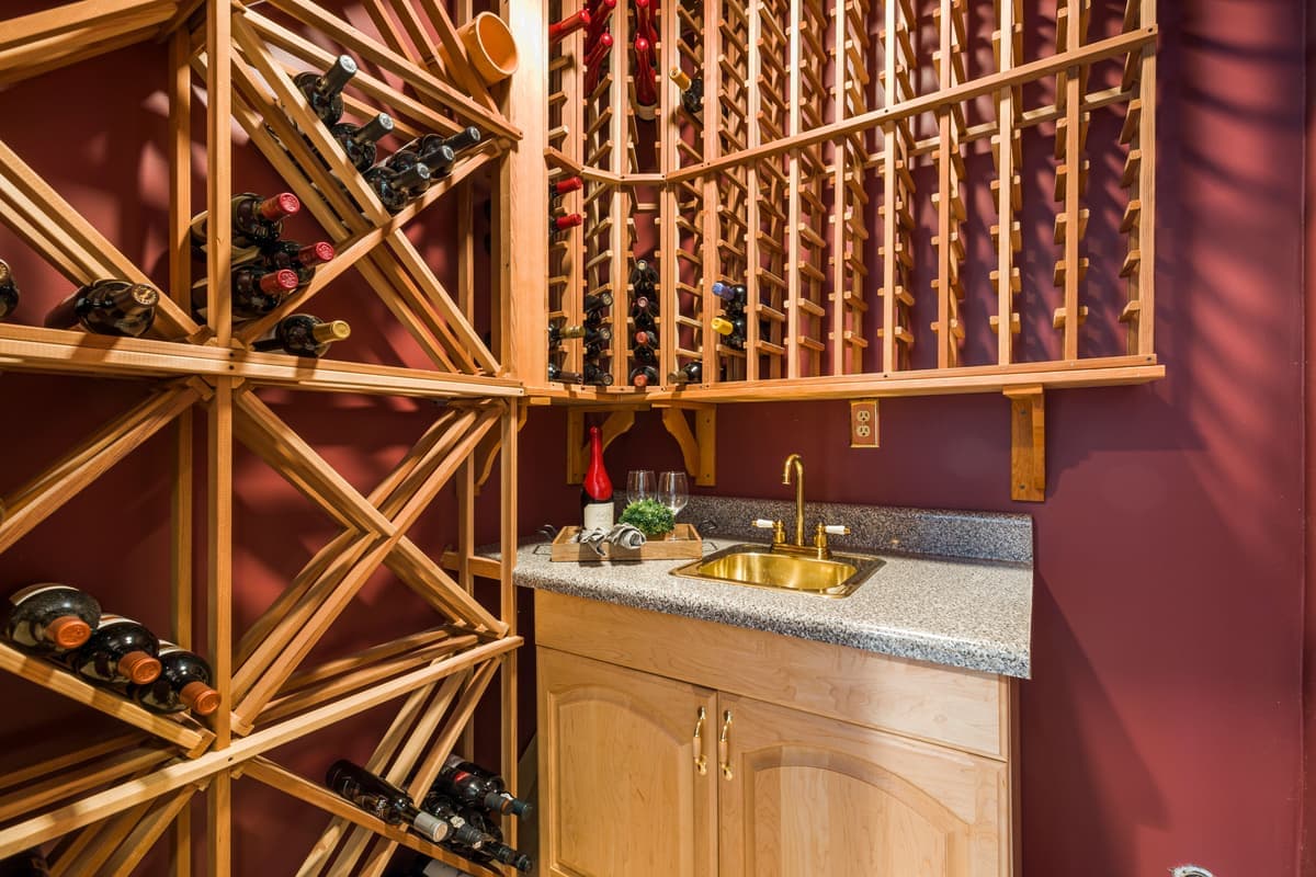 A wooden floor-standing wine rack filled with bottles