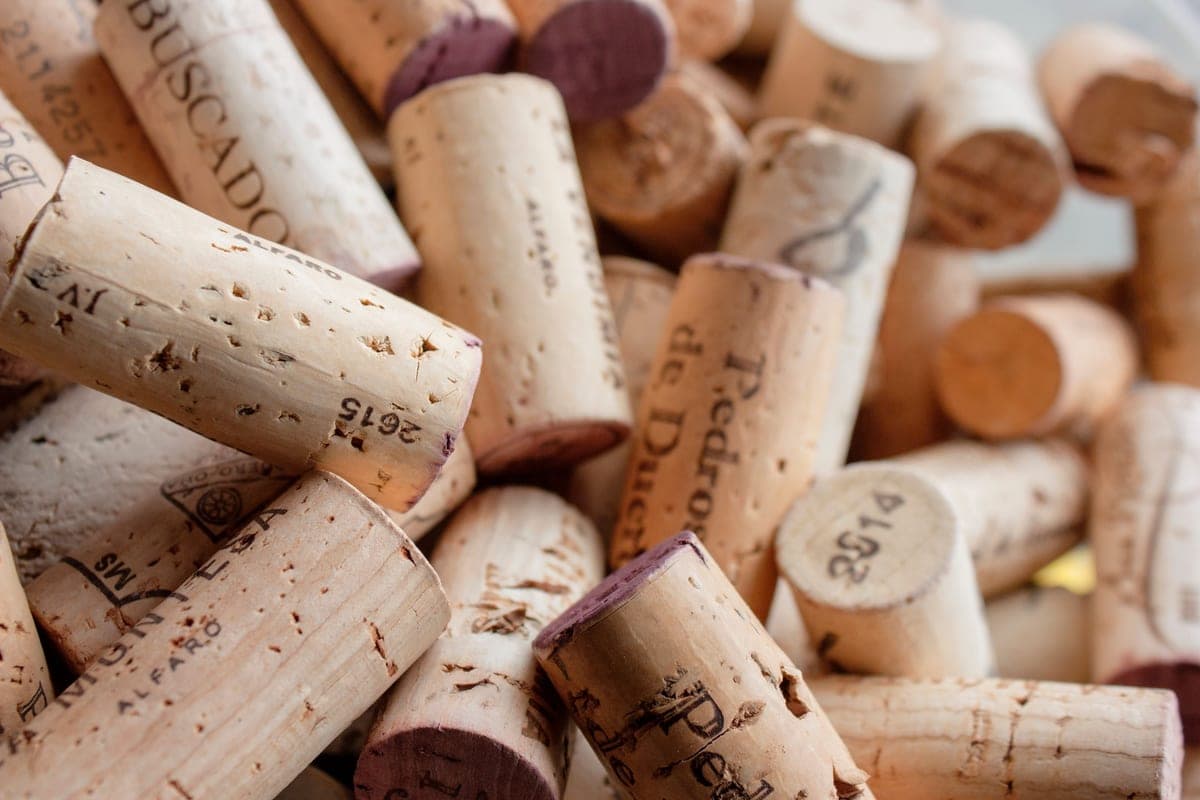 A close-up of used wine corks showing their textures