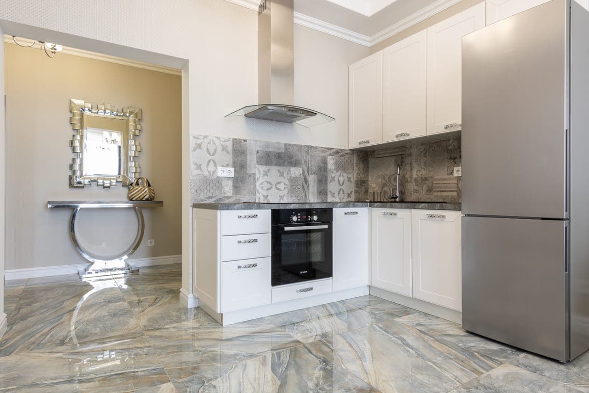A fitted kitchen with a built-in oven and appliance housing