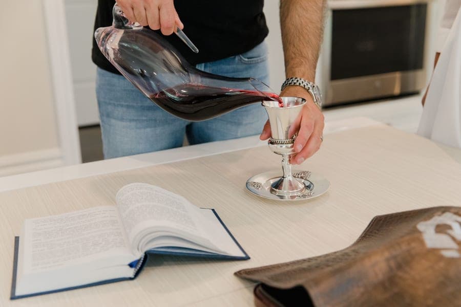 Red wine being poured from a glass decanter